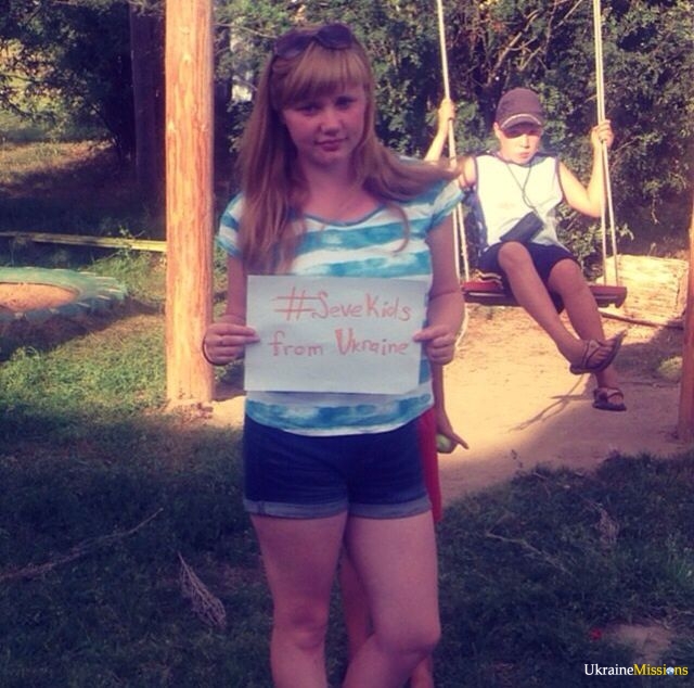 another girl holding a sign